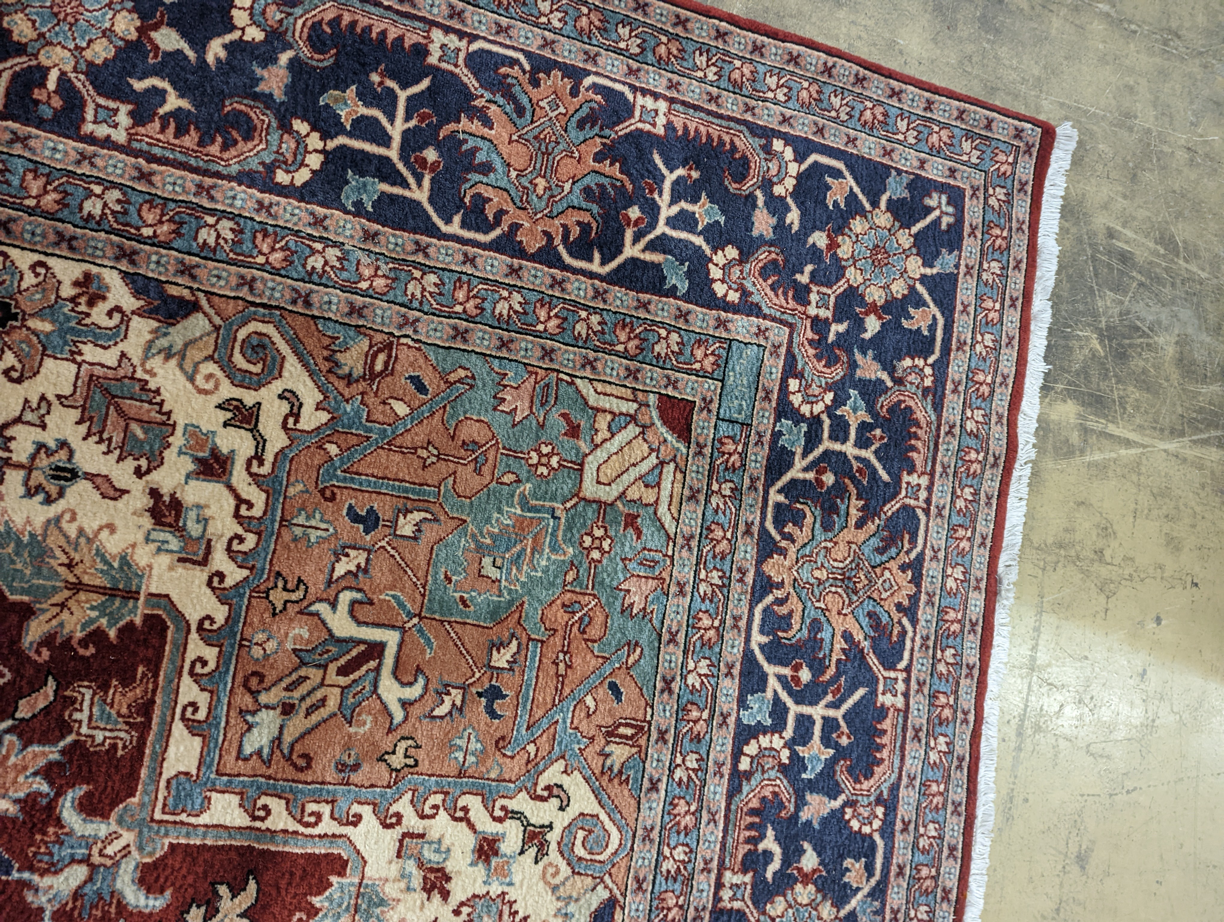 A large Caucasian style red ground carpet, 460 x 330cm